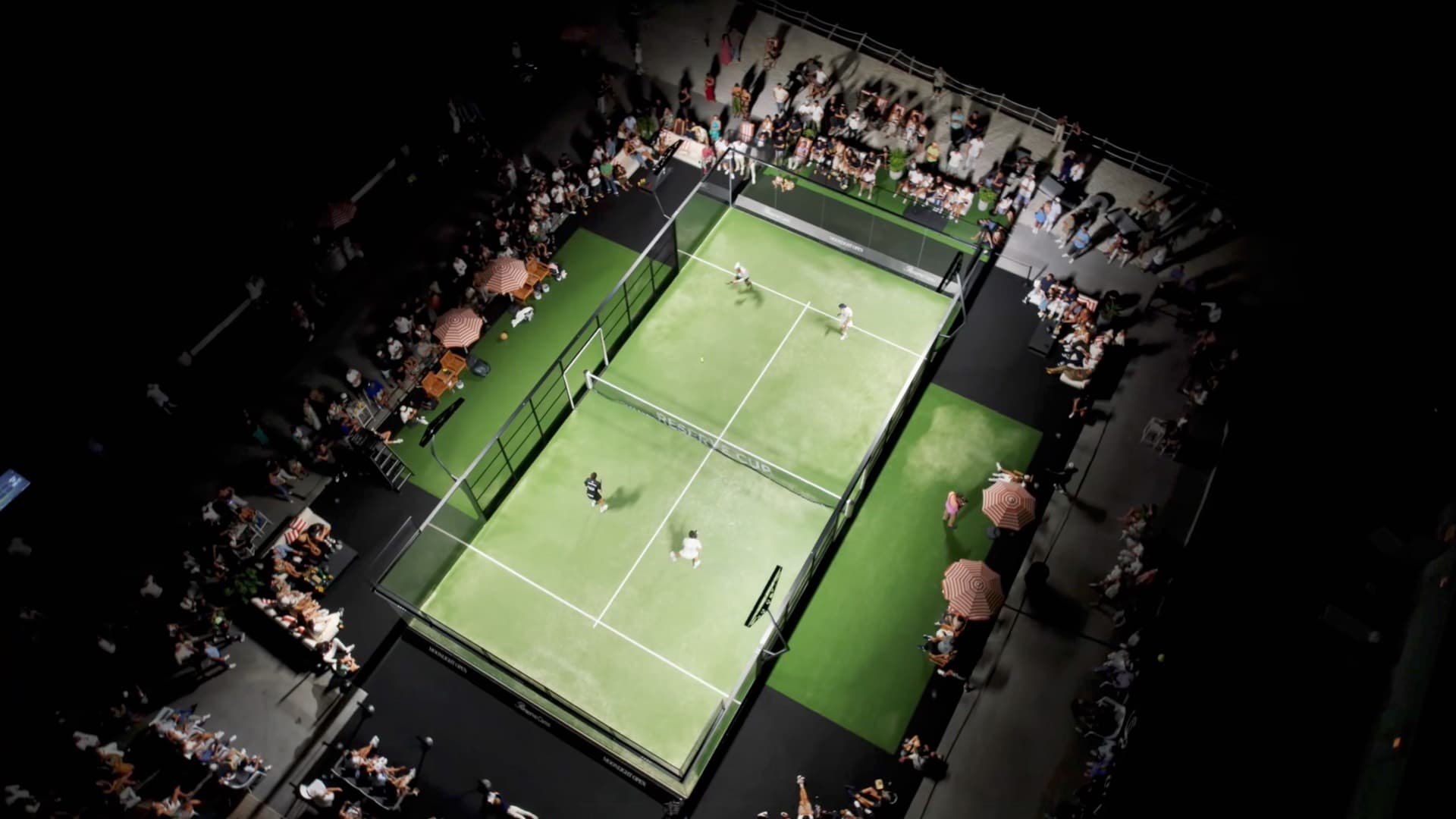 Night aerial of a floodlit court at a premium live event, filmed by Lennox Visuals